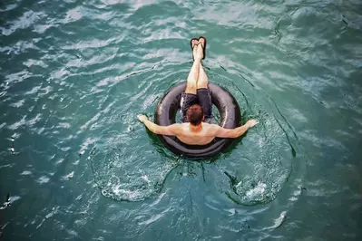 man tubing on river